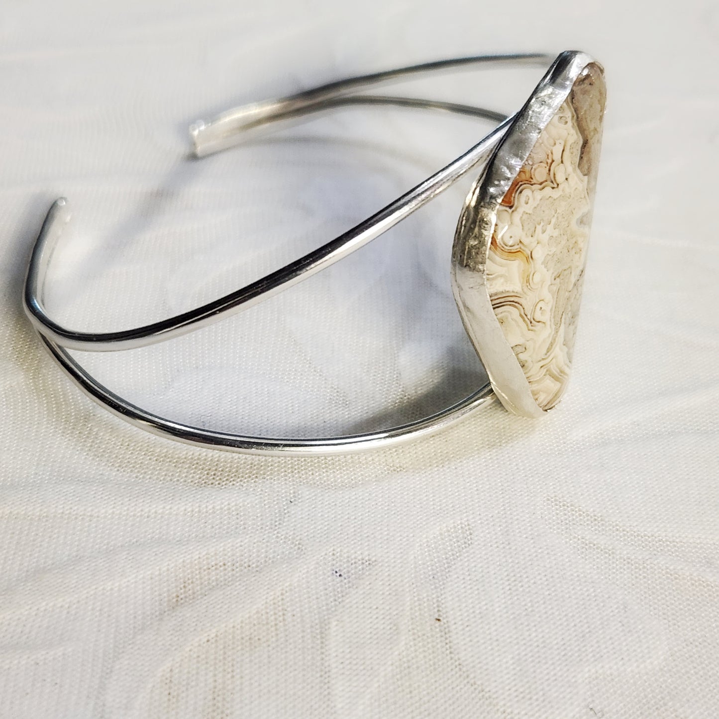 Close-up of Crazy Lace Agate split cuff bracelet, highlighting unique stone pattern.