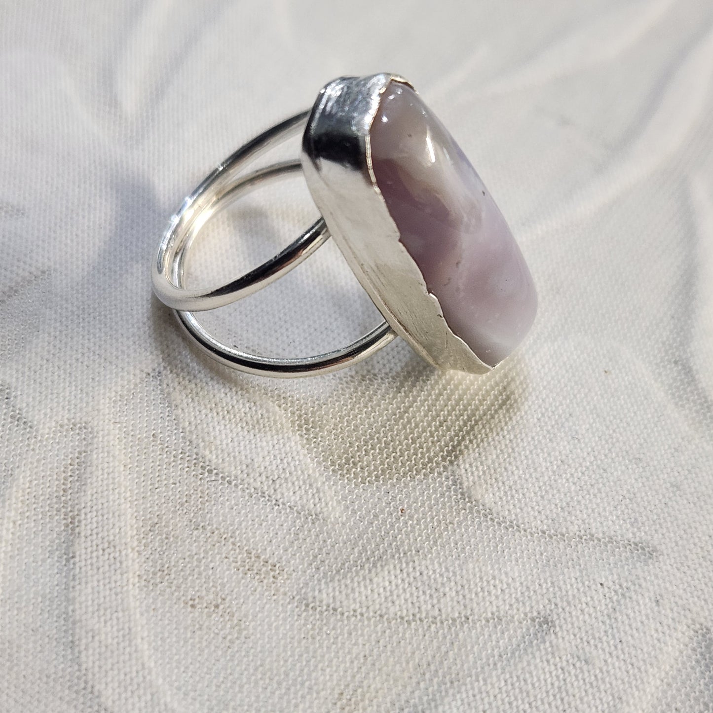 Close-up of the bezel and stone texture, showing intricate silverwork and natural patterns in the agate