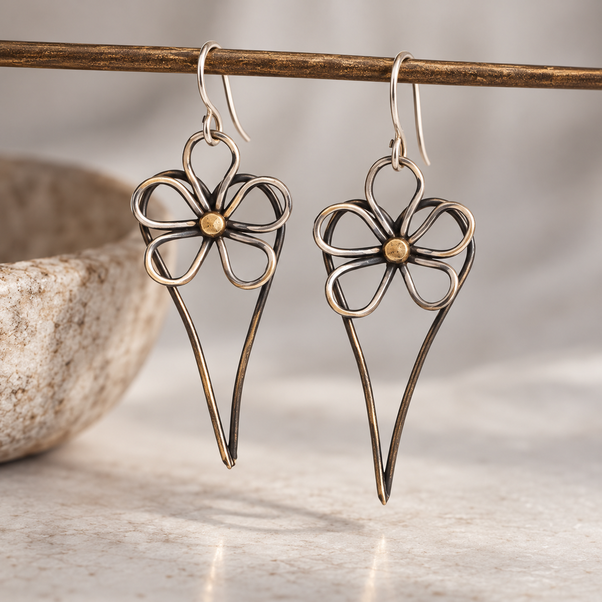 Pair of Wild Rose Heart Earrings featuring five open silver petals, warm gold centers, and elongated oxidized heart silhouettes, designed by Lepa Jewelry.