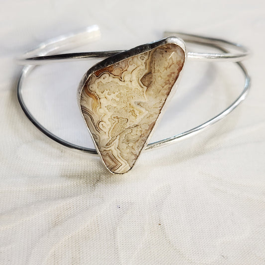 Crazy Lace Agate split cuff bracelet in sterling silver – front view on white background.
