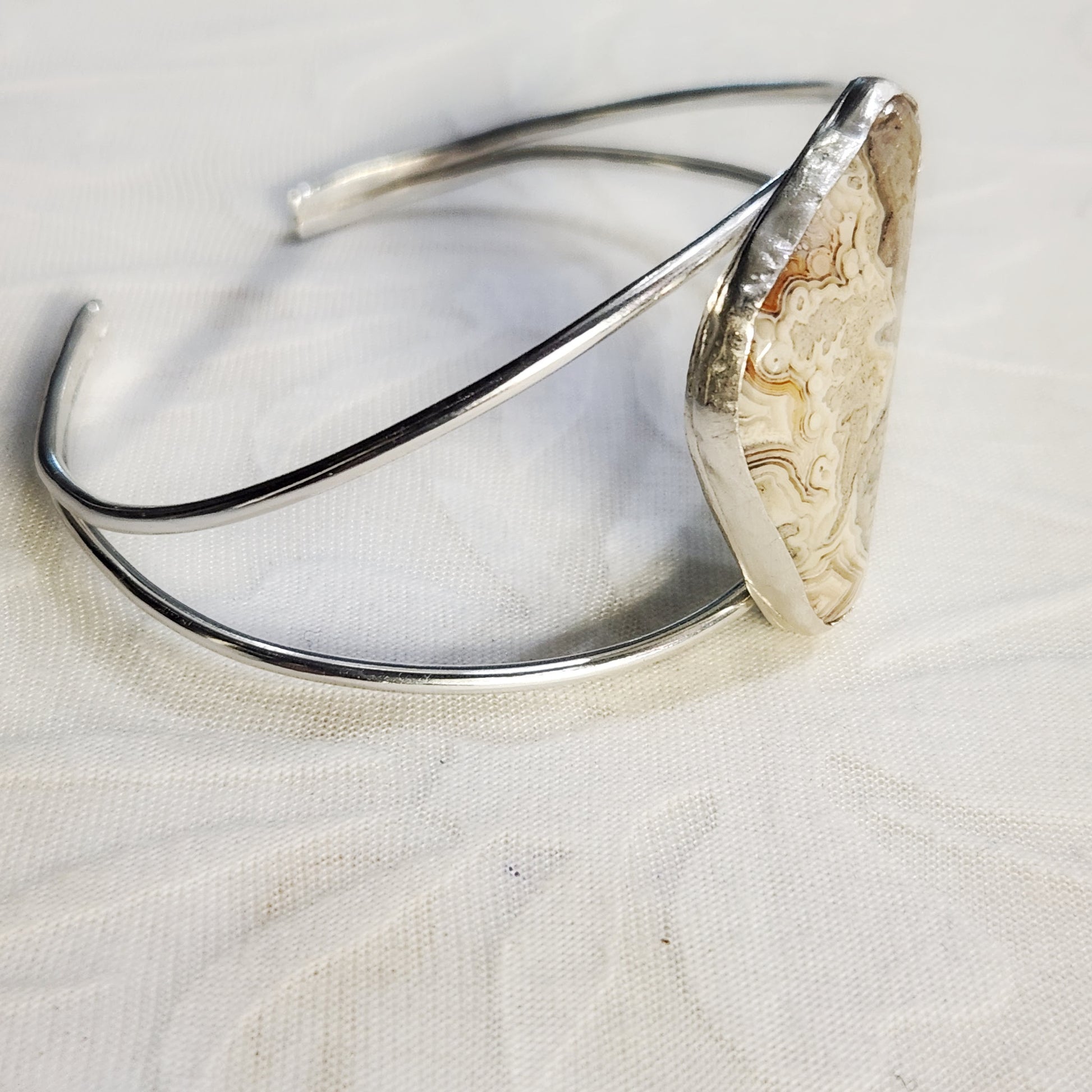 Close-up of Crazy Lace Agate split cuff bracelet, highlighting unique stone pattern.
