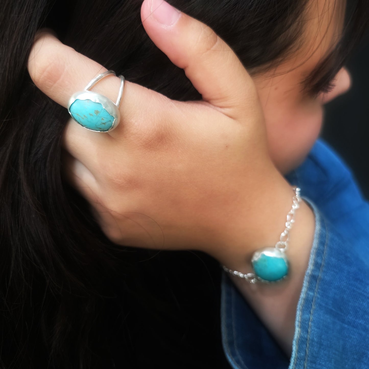 Side view of turquoise ring and bracelet set in Argentium silver.