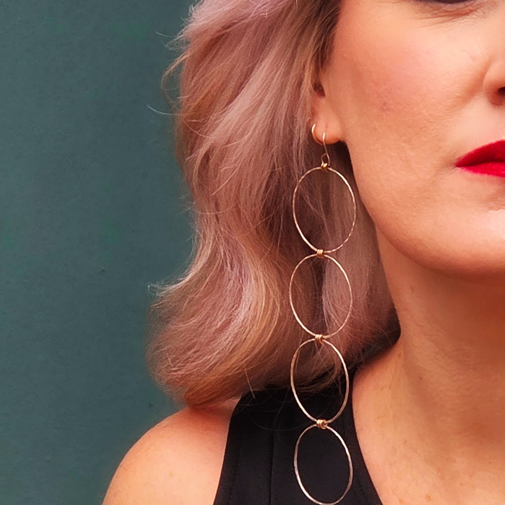 Close up of a powerful woman wearing Lepa Jewelry's Linear Luxe signature earrings
