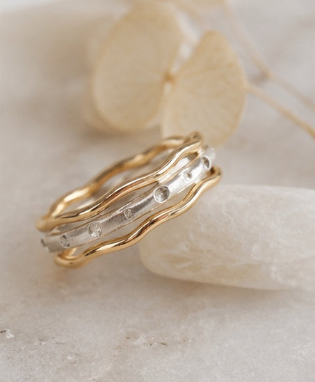 Trivera Ring Set worn on hand showing sculptural wave profile and mixed metal contrast