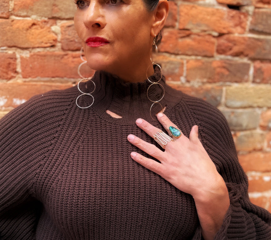 Aegis Ring styled with other statement jewelry on model, bold sculptural gold ring by Lepa Jewelry