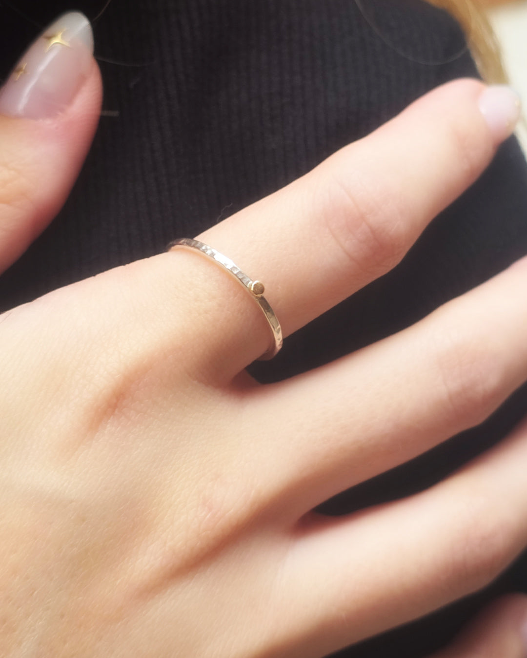 Close-up of The Golden Moment Ring worn on the hand, revealing the subtle texture of the hand-forged Argentium silver band and 14k gold detail.