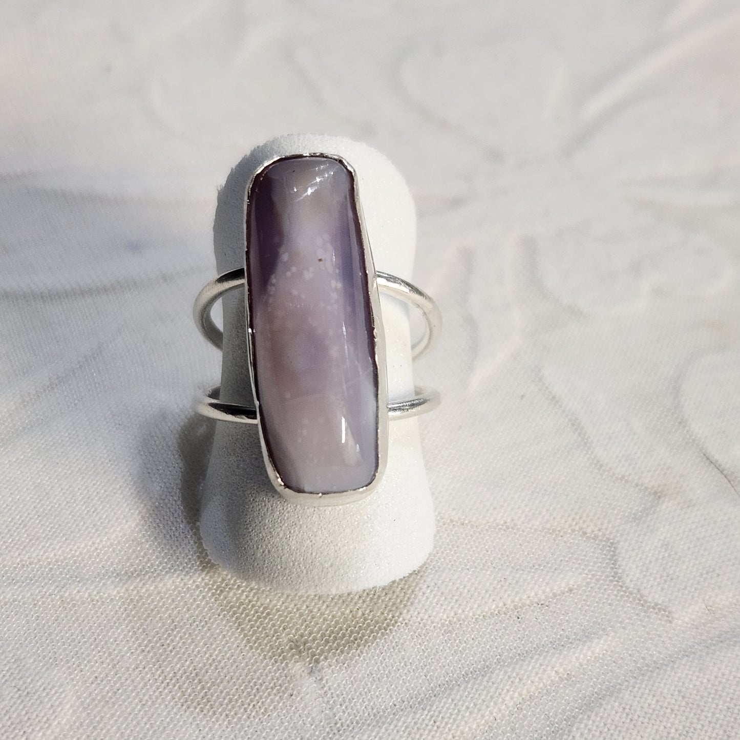 One-of-a-kind lavender agate ring shown from the front, featuring a fine silver bezel and soft purple hues