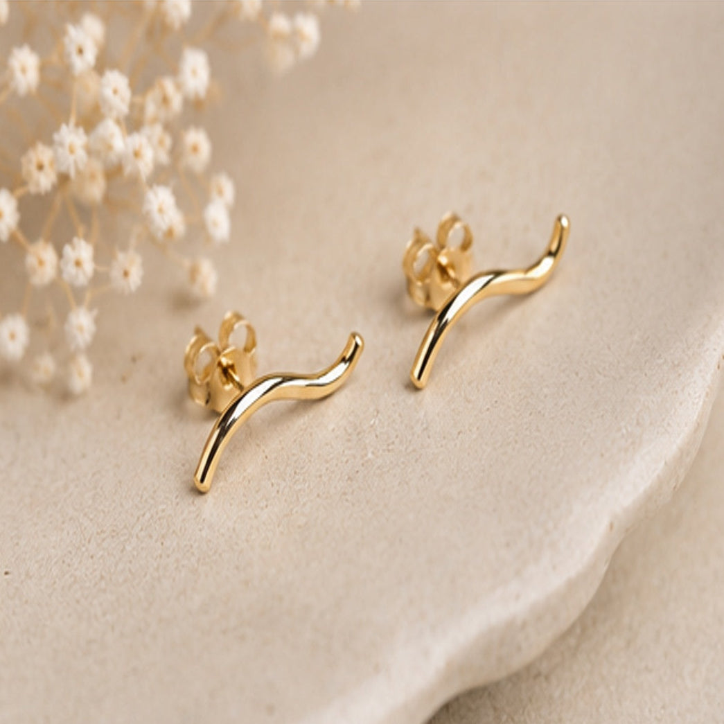 Side profile of curved wave stud earrings showing sculptural form and flow, minimalist handmade earrings by Lepa Jewelry