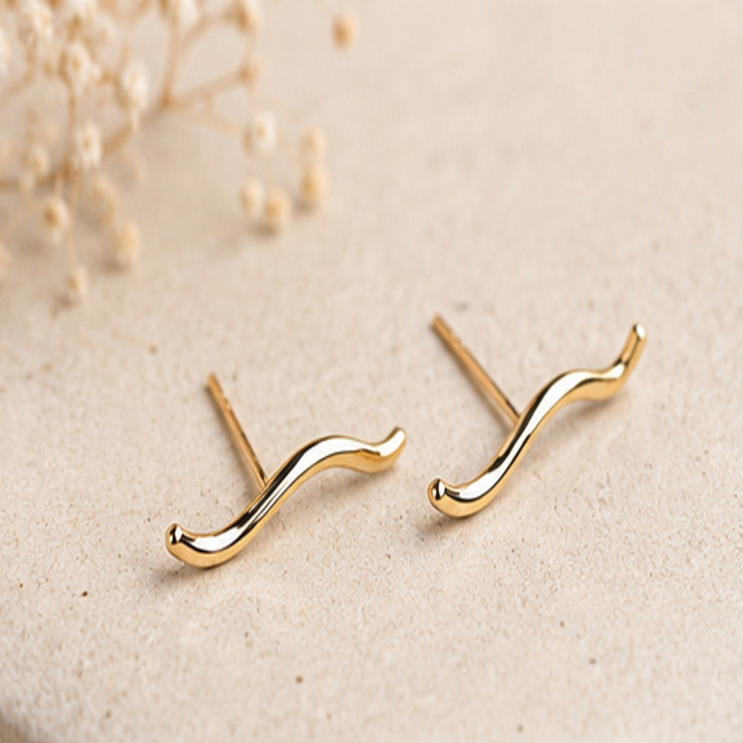 Gold-filled sculptural wave stud earrings by Lepa Jewelry, modern curved studs with a fluid minimalist design in warm gold
