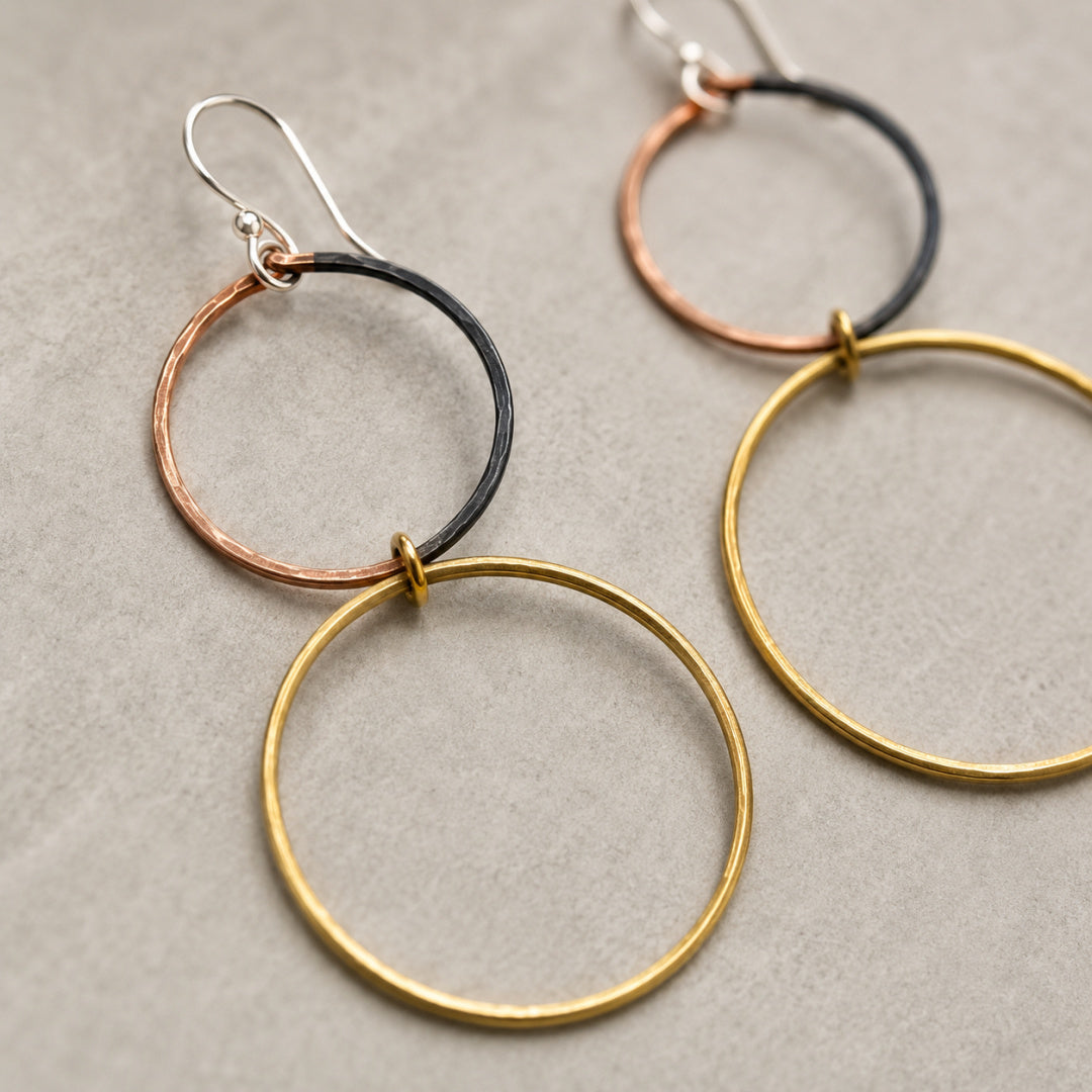 Close-up of the Meridian Hoops showing the brass circles, partially oxidized copper circles, and Argentium silver earwires