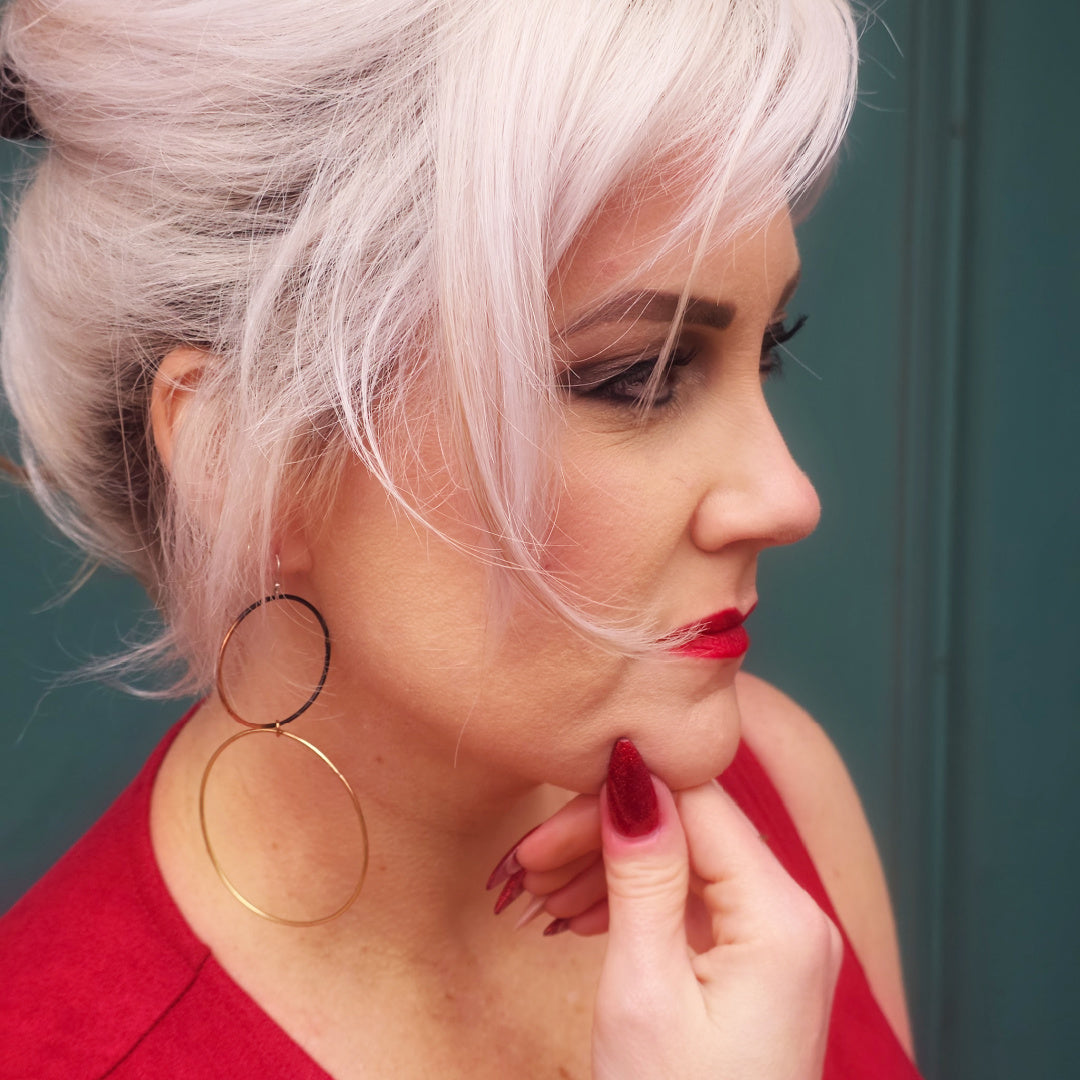 Meridian mixed metal statement hoops worn to show their long scale and movement